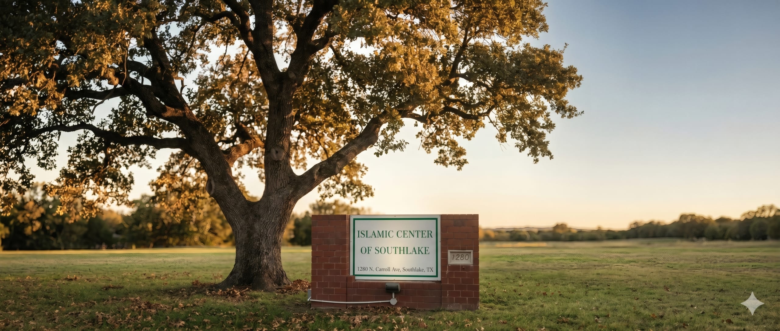 Brick Islamic Center of Southlake sign beneath an oak tree at golden hour