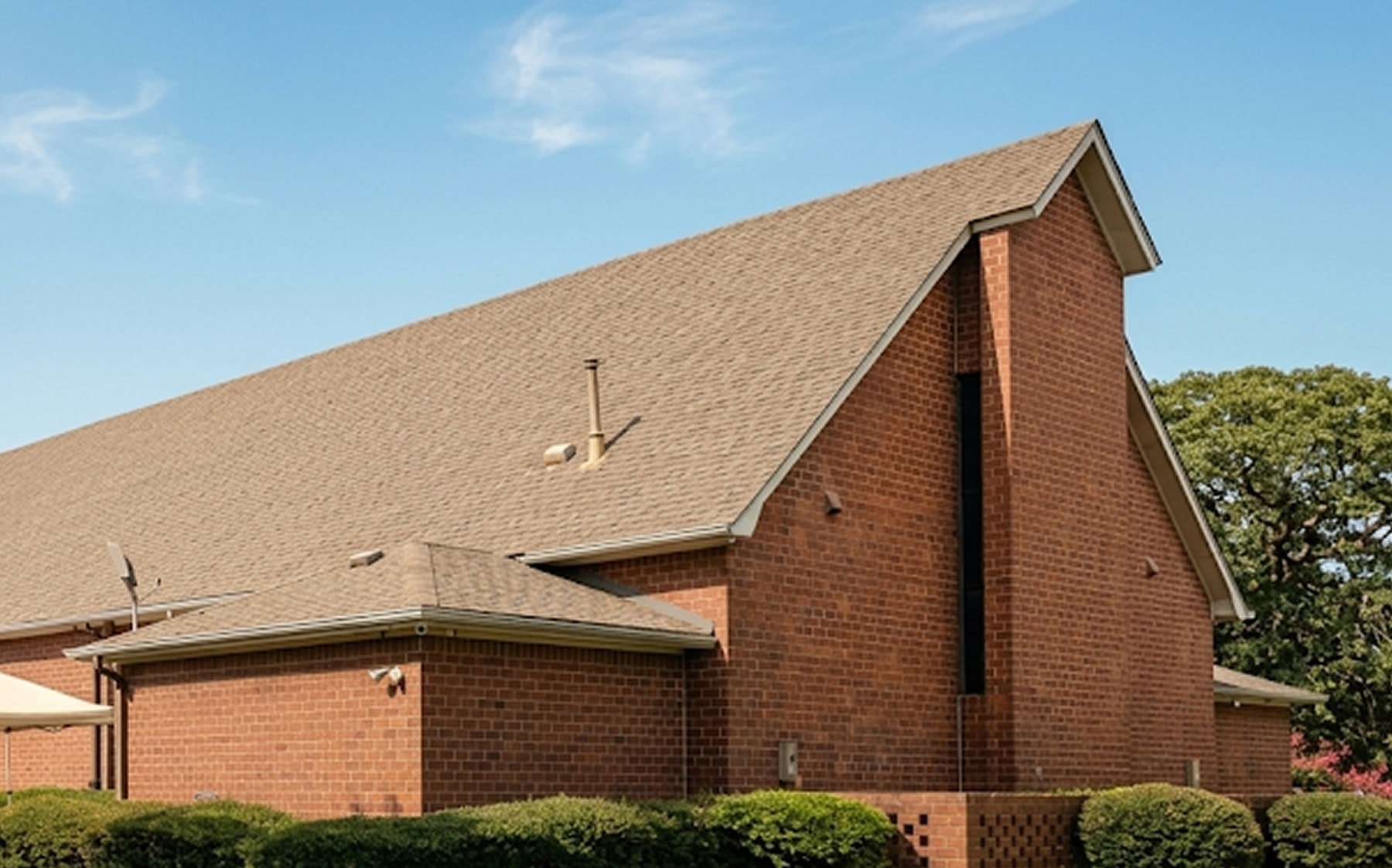 The brick gable and roofline of the Islamic Center of Southlake against a blue sky