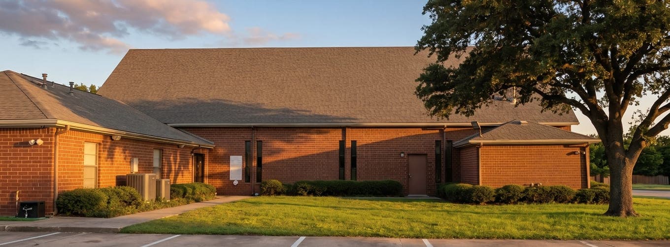 The exterior of the Islamic Center of Southlake at golden hour with mature trees