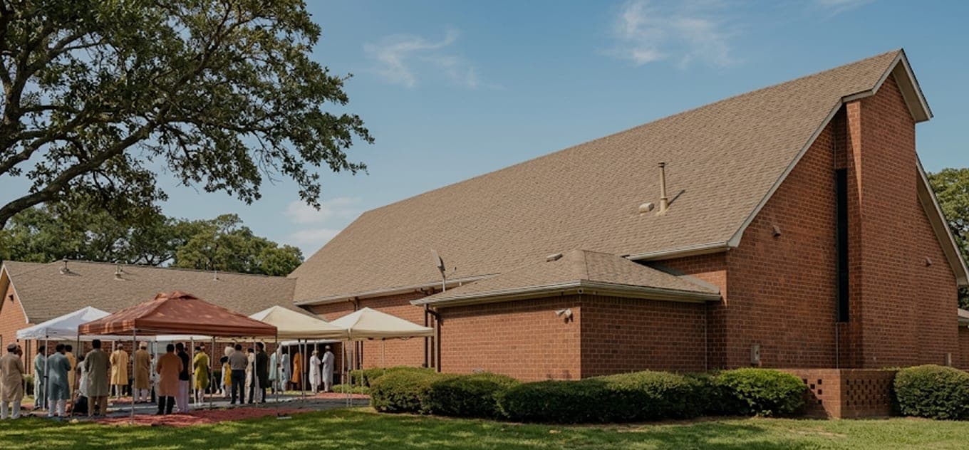Exterior of the Islamic Center of Southlake with community tents on the lawn